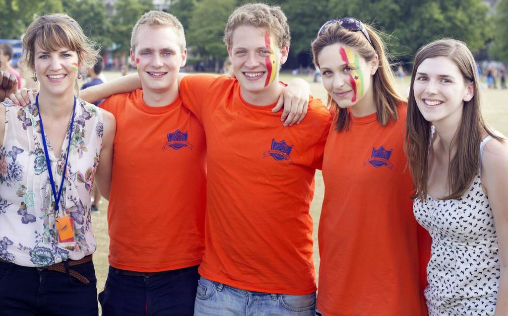 Reach Cambridge staff, faces painted with the colours of the Ghana flag on our July Sabre day